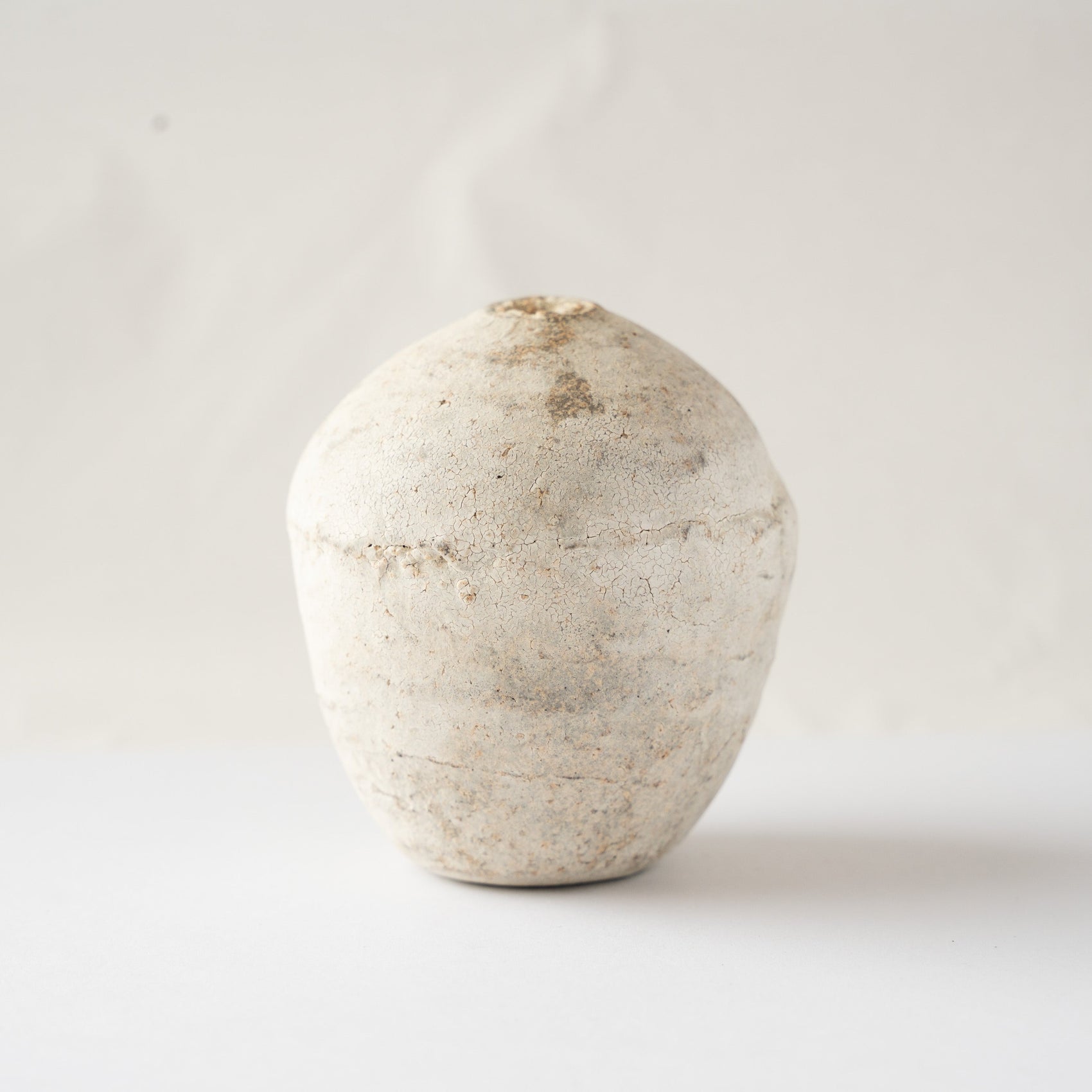 Alternate turned view of the Hakkoku Ko HANAIRE flower vase by Wataru Myosyu, detailing the weathered mineral-like ceramic texture.