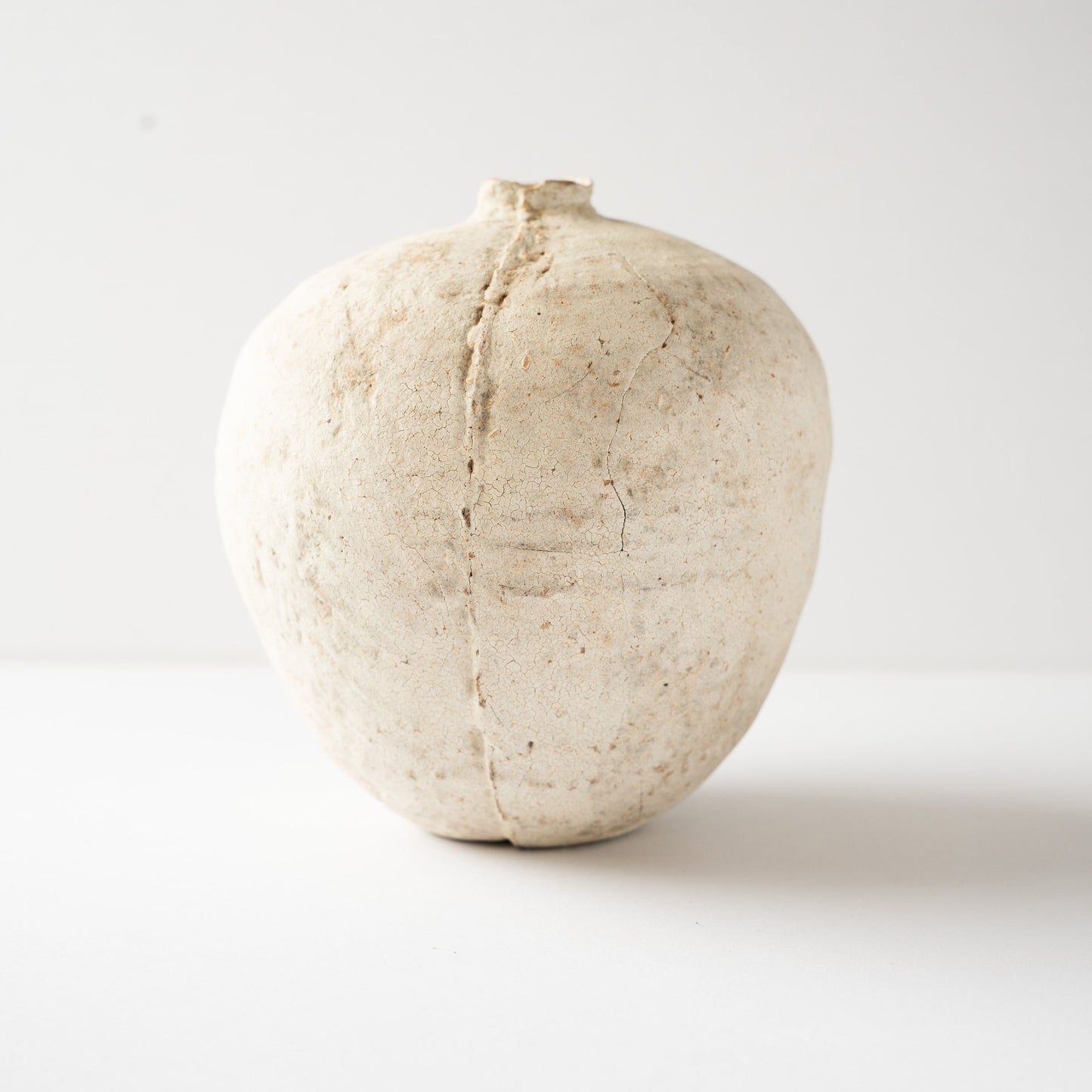 Full view of the Hakkoku Tada ceramic HANAIRE vase by Wataru Myosyu, accentuating its minimalist form and quiet presence against a white studio background.
