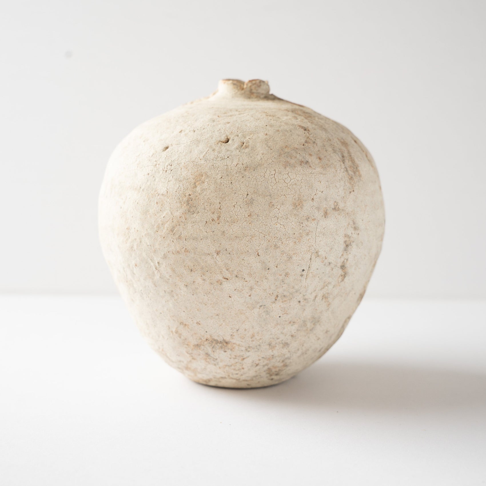 Smooth side facade of Wataru Myosyu’s Hakkoku Tada white ceramic vase, detailing the subtle iron specks and crackle glaze.