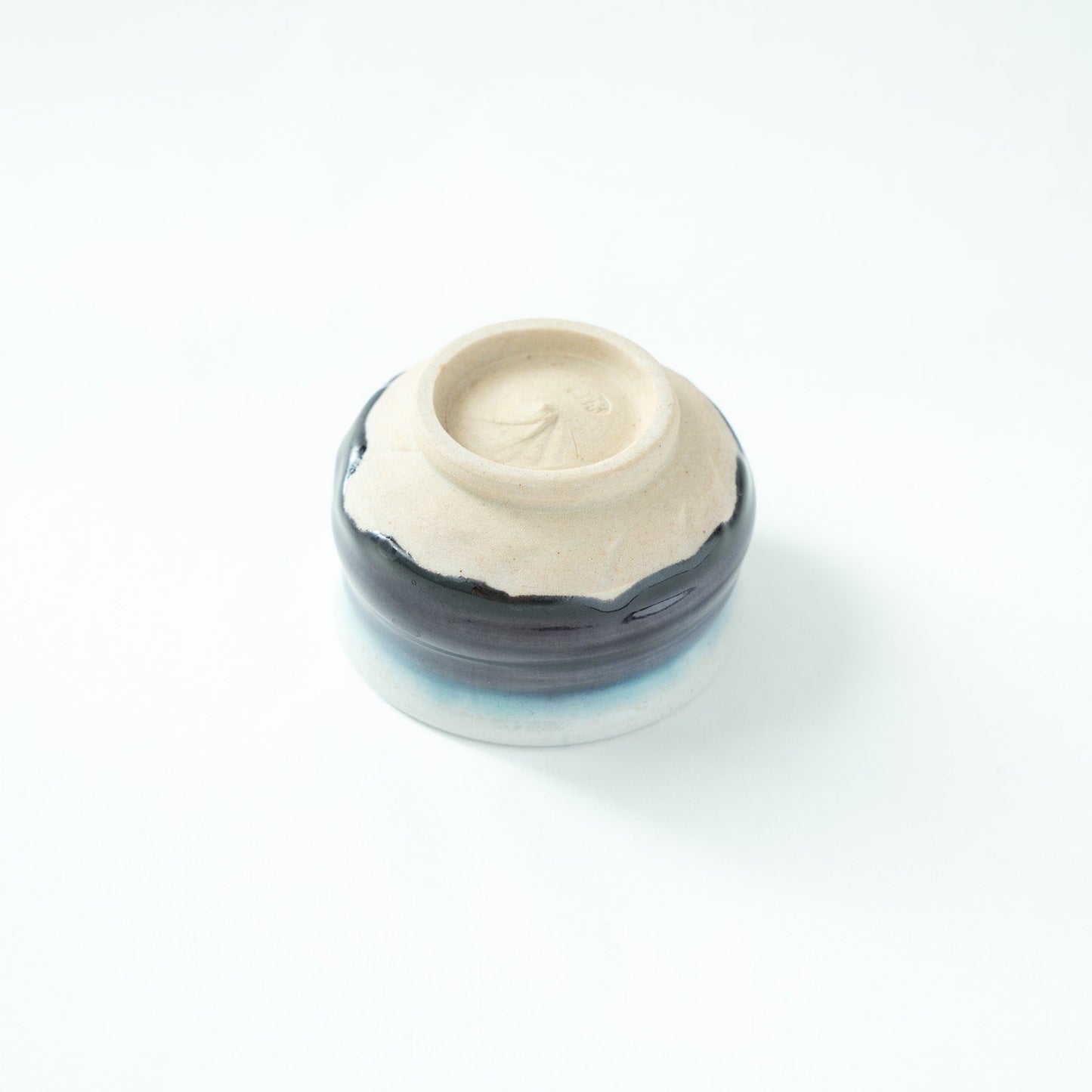 Detailed view of the clean white ceramic foot (kodai), emphasizing the refined materiality and signature trace of contemporary Kutani ware.