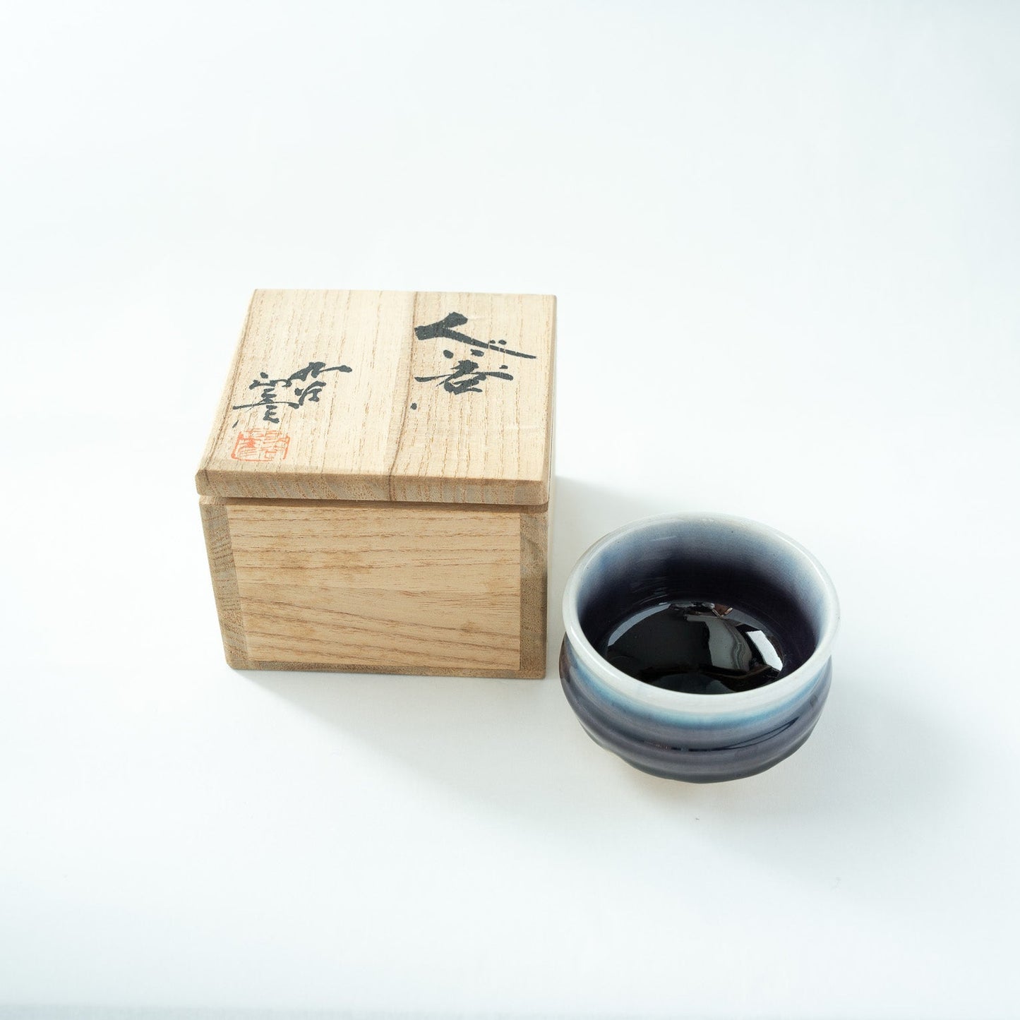 The blue gradation Kutani GUINOMI presented alongside its original inscribed wooden box signed by the artist.