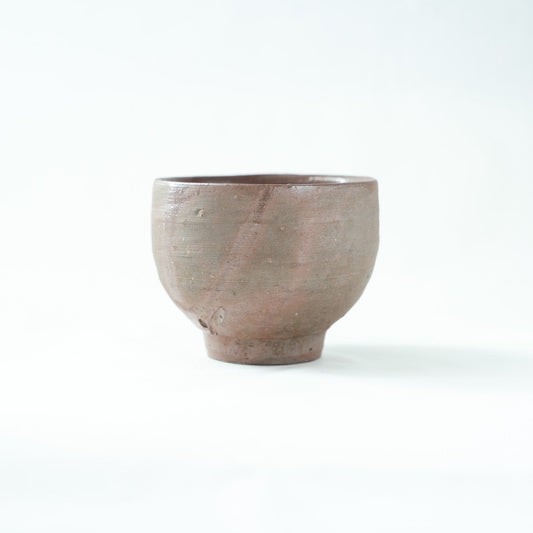 Side view of the Bizen sake cup, revealing soft reddish flame marks produced by natural kiln transformation.