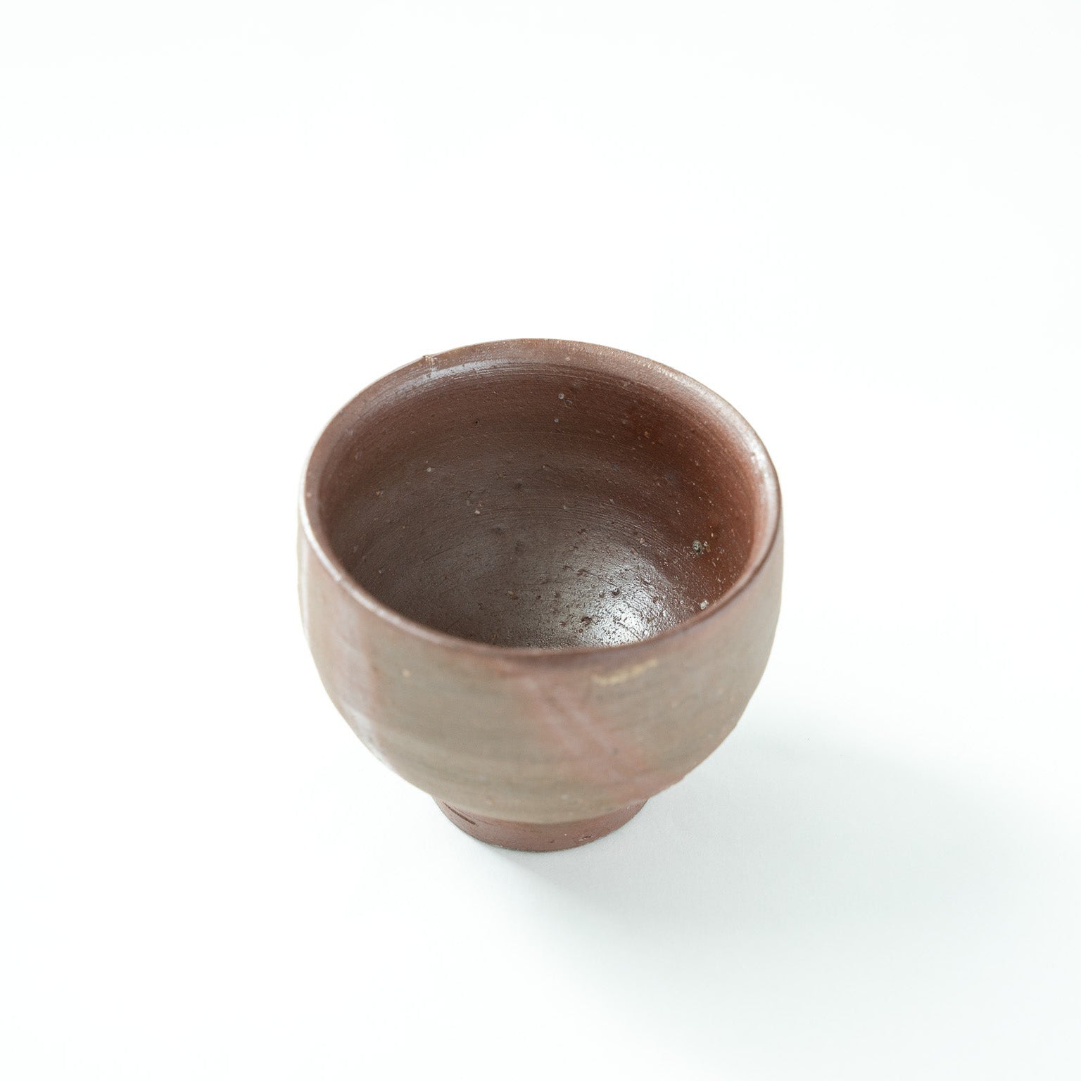 Top-down angled view looking inside the smooth, unglazed interior of the Bizen GUINOMI.
