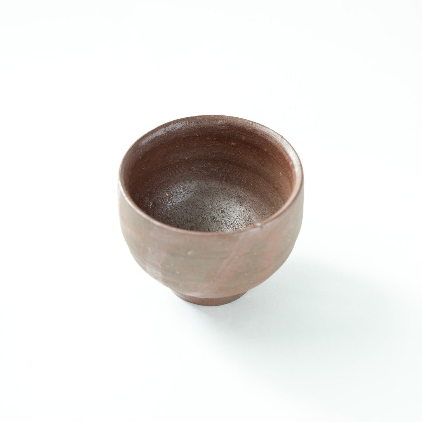 Interior view from a slightly higher angle, showing the natural matte gloss and subtle specks within the clay bowl.