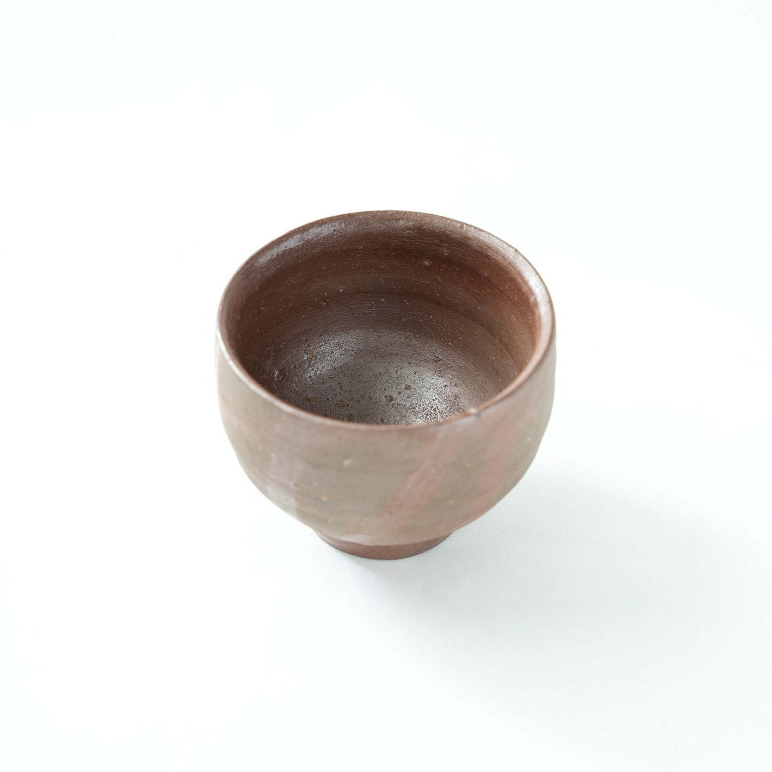 Interior view from a slightly higher angle, showing the natural matte gloss and subtle specks within the clay bowl.