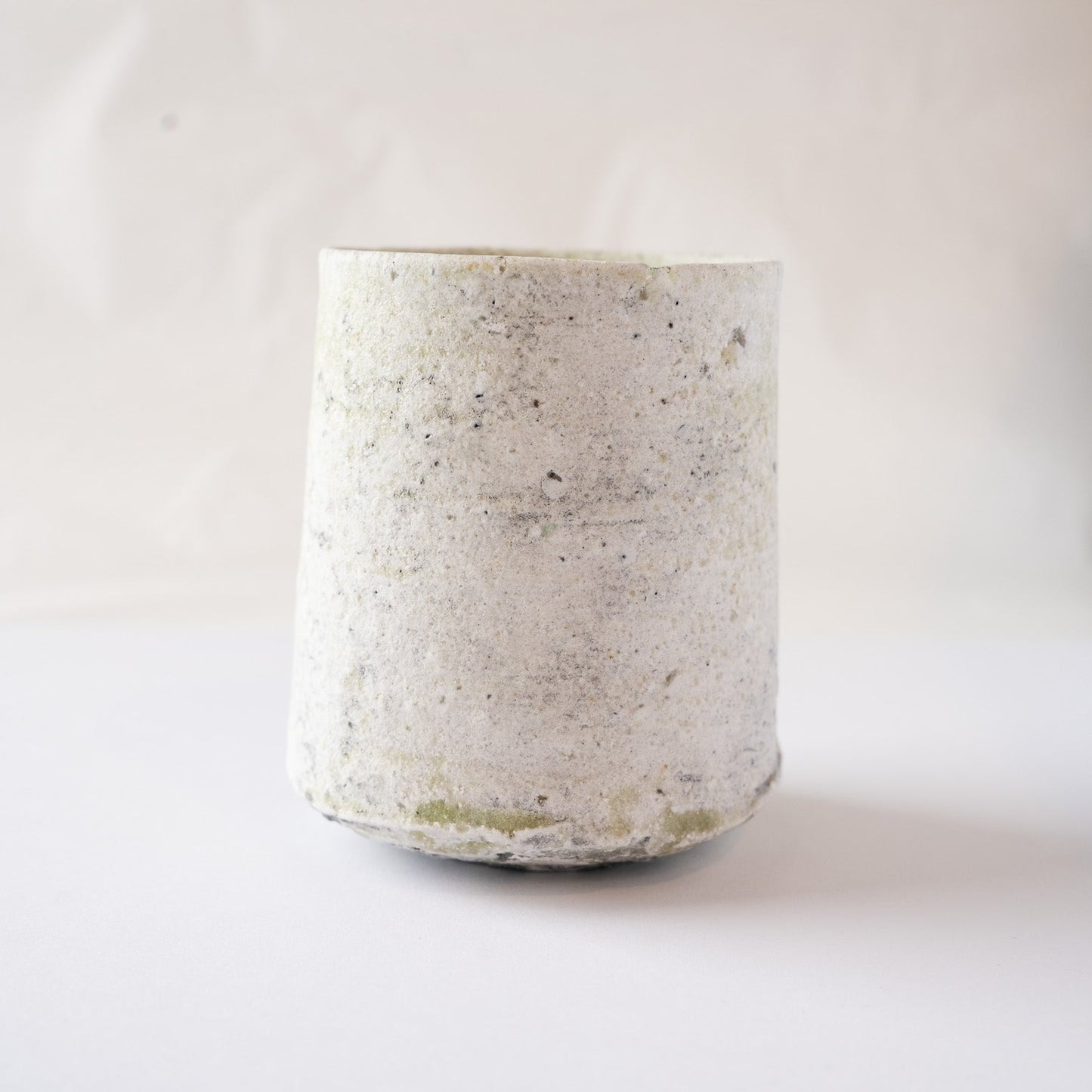 Alternative side view focusing on the clean, rustic white ash finish and the subtle asymmetrical entry of the green glaze at the bottom.